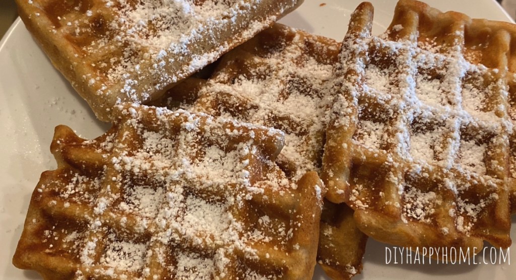 Apple Cinnamon Waffles dusted with powdered sugar​